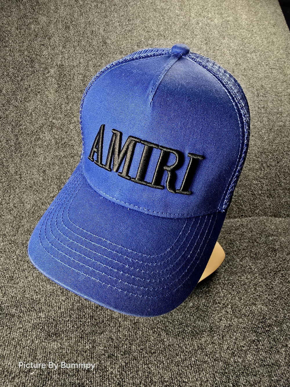 Amiri Core Logo Trucker Hat in a blue and black colorway